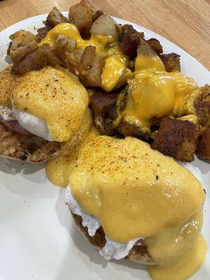 Eggs Benedict with home fries and cheese