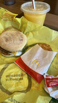 Sausage egg McMuffin, hash brown, OJ.