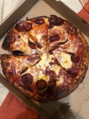 Large pepperoni and bacon with extra cheese extra pepperoni and bacon. This pizza has neither and it's burnt!