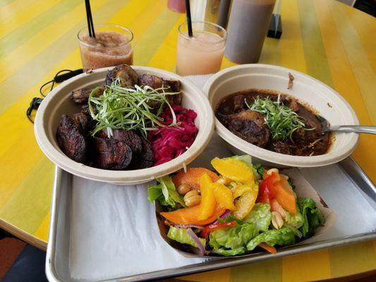 Lunch bowl special (jerk chicken). Oxtail bowl on the right. Side salad middle.