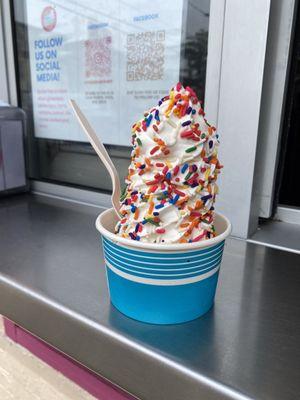 Regular SOFT SERVE in a cup with rainbow sprinkles