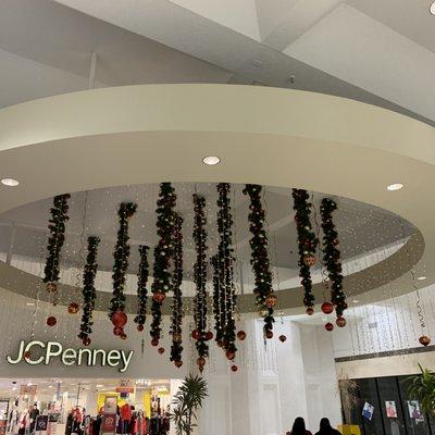 Christmas decorations hanging on ceiling near the entryway of JCPenny.