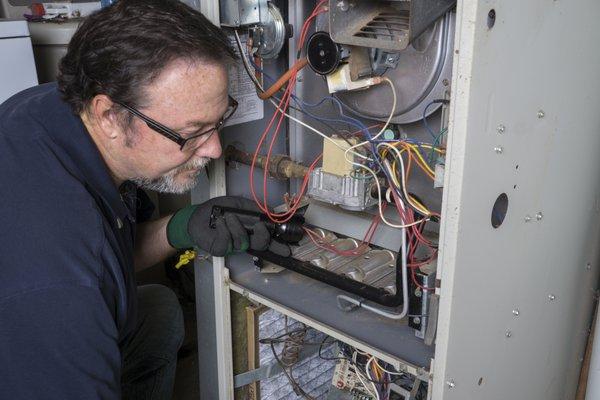 Technician fixing the Heating system furnace