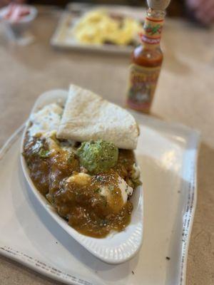 Chicken, green chili Hash, Eggs were under the chili sauce.