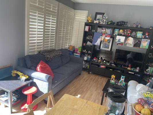 Kids' playroom. She cleaned beneath the entertainment center, sofa, and side table.