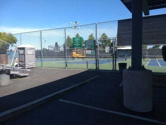 entrance chained shut, with clock board, porta potty and benches for waiting players