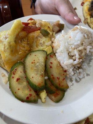 Smaller plate of steamed rice, shrimp omelette, and cucumber kimchi.