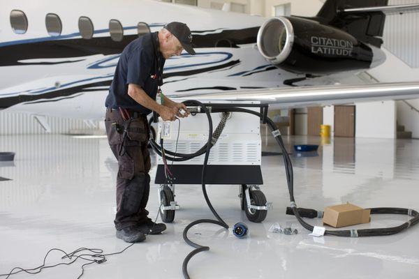 Installing power toa Ground Power Unit to start a jet at the airport