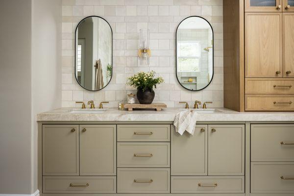 Remodeled primary bathroom with custom cabinets with spa tower, brass plumbing & quartzite countertop