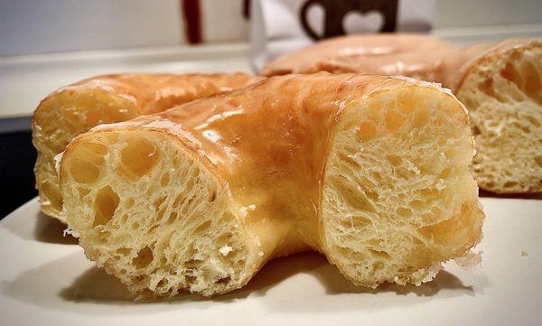 Cross section of glazed donut. Light, airy, tender yet chewy.