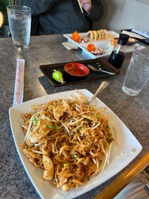 Pad thai noodles and sushi.