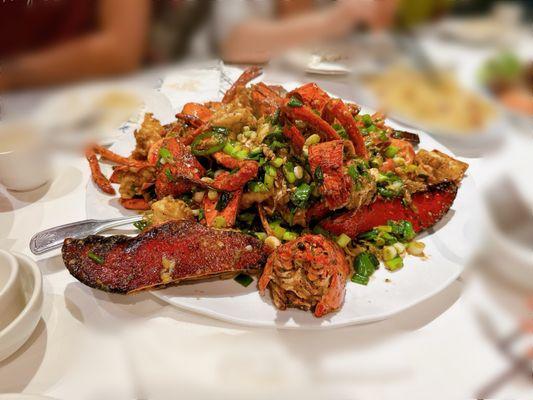 Large House Lobster ( 8-10 lbs) stir-fried with green onions, garlic jalapeño, served on a bed of garlic noodles.