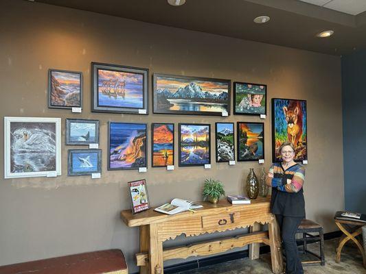 Artist Leslie Yamada with her paintings in the tasting room.