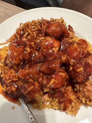 Half of the portion of General Tso chicken with pork fried rice and noodles