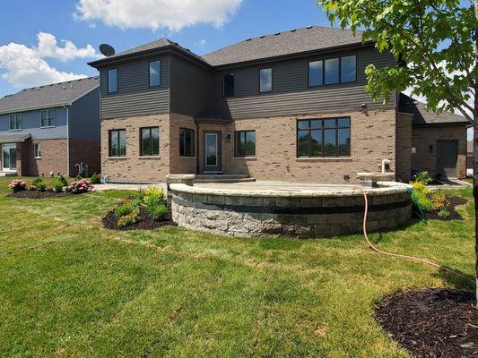 Woodridge- Sierra Westport with Series 3000 black accent and Sandstone Brussels edge 3 tier patio with step down firepit area and seatwall