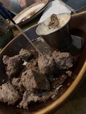 Steak bites with creamy horsey sauce.