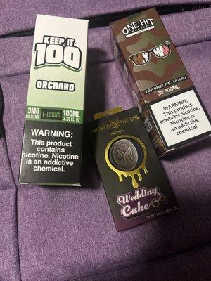 Two different types of E-liquid and a Wedding Cake Indica disposable.