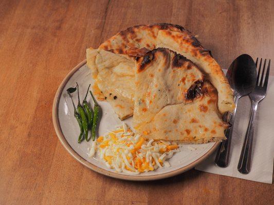 Spice up your day with our delicious Chilli Cheese Naan! Plunge into this irresistible delight!