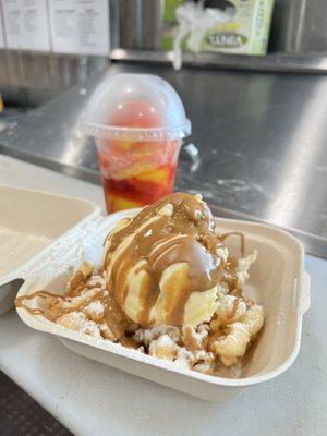 Funnel cake with powdered sugar, butter cookie drizzle and vanilla ice cream.