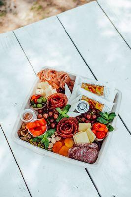 Indulge in charcuterie bliss with our portable boxes at Signor Vineyards! Experience the same delightful ingredients on the great lawn.