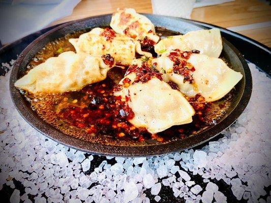 Pork Dumplings (6), pan fried & served on a hot skillet with Chile & sea salt!