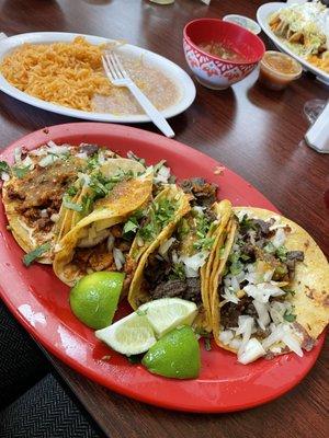 Steak and al pastor tacos with a side of rice and beans