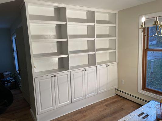 Homeowner had a great idea to combine cabinet uppers with custom shelving for this unique built-in bookcase.