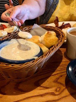 Bowl of gravy. Basket of biscuits