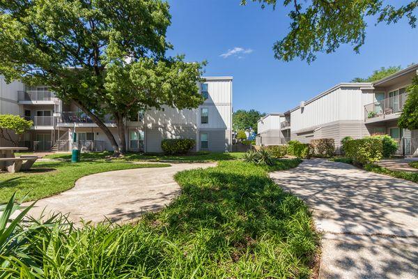 This is a photo of building exteriors and the grounds at The Biltmore Apartments, in Dallas, TX.