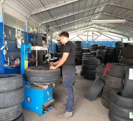 Antonio working on a customer's tire