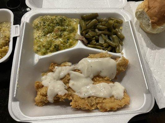 Chicken fried chicken with cream gravy, broccoli casserole, green beans, dinner roll