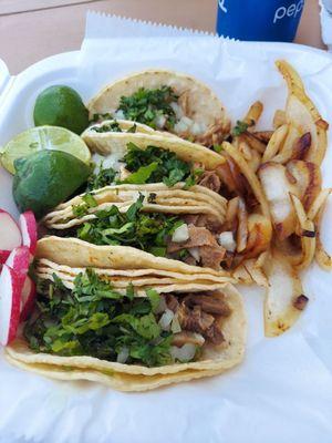 Street tacos. 2 lengua and 2 carnitas, all with cilantro and diced onion. Accompanied with lime, radish and grilled onion.