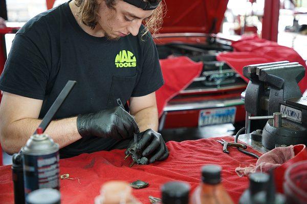 John rebuilding a carburetor.