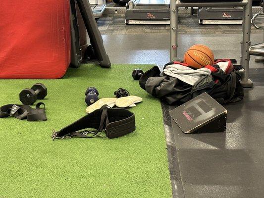 Gym floor with someone's duffel bag of personal items. Was blocking equipment until someone moved it.