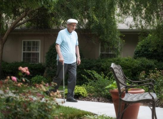 A resident enjoying a walk in our newly renovated courtyard.