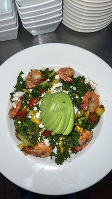 Pacific coast salad: garlic prawns, avocado, mango,cucumber, corn,tomatoes, kale, goat cheese, and cilantro lime vinaigrette