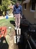 Pulling a new sewer line via Trenchless Piupe Bursting Method. (Dan is operating the hydrolic pully )