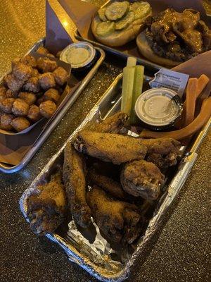 Huge wings and bomb sweet potato tots! Cheeseburger in the background.