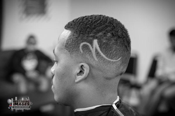 Simple design on a bald fade