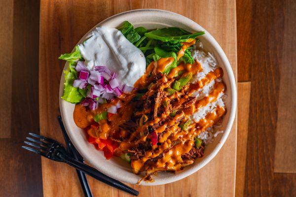 Tender Beef Barbacoa Rice Bowl with Spinach, Onions, Tomatoes, Sauteed Green Peppers, Chipotle and Tzatziki.