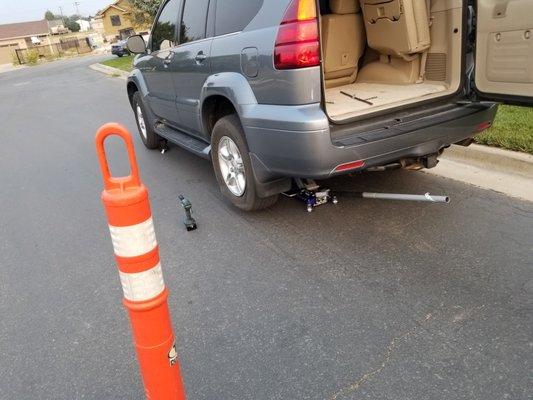 Tire Change in West Jordan, Utah. Cones out for safety,  wheels chocked properly.