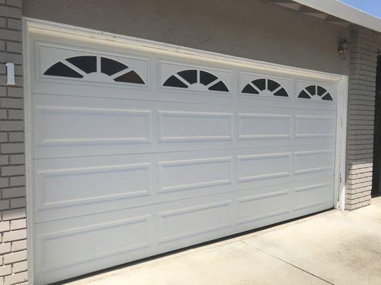 15x7 white long panel clopay door with obscure glass and sunset window designs.