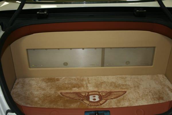 Bently upgraded audio system. Amp rack with custom trunk panels, Custom trunk floor mat with logo