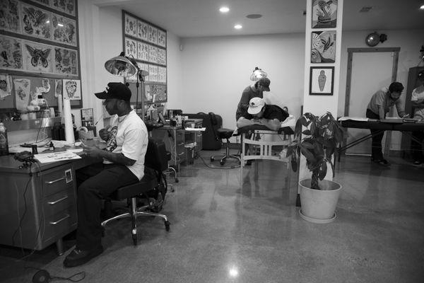 Our Shop!
Jordan Drawing 
Josh Tattooing away 
Wayne having a Tattoo Consultation in the back.