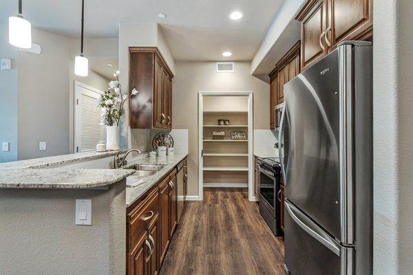 Gourmet kitchen with stainless steel appliances and espresso cabinetry