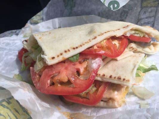 Chicken breast on a flatbread with lettuce, tomato, shredded cheese, jalapeños and chipotle sauce.