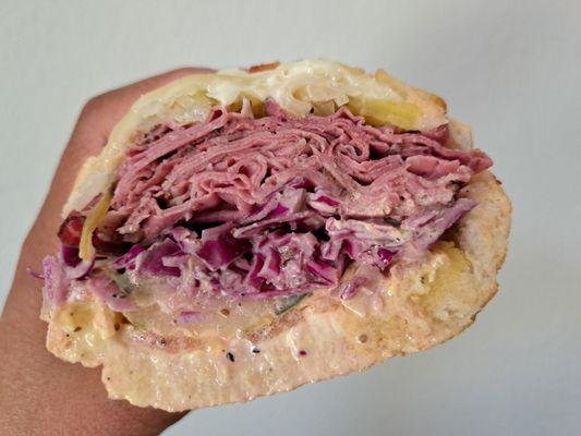 #8 1/2 pound of Pastrami, Swiss cheese, sauerkraut, house slaw, house dressing on Dutch Crunch bread