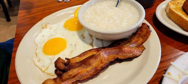 Two eggs, bacon, and grits