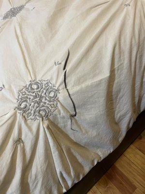 White bedspread with black Sharpie. No response from AAA for replacement.