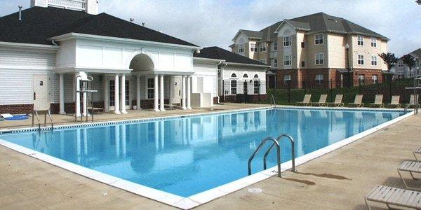 a large swimming pool in front of a building